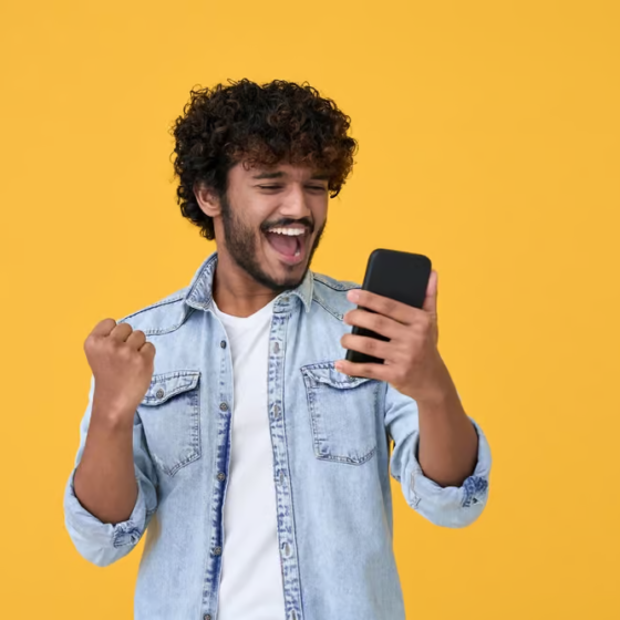 Happy customer paying his phone bill on his phone